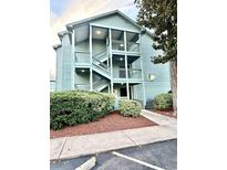 Light teal multi-unit building with exterior stairs and landscaping at 5905 S Kings Hwy. # 4112, Myrtle Beach, SC 29575