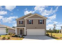 Two-story house with neutral siding, and a two-car garage at 632 Grateful Dr., Little River, SC 29566
