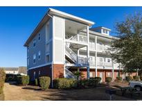 Three-story building with brick and siding, featuring stairs and balconies at 804 Crumpet Ct. # 1151, Myrtle Beach, SC 29579