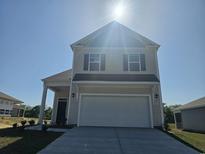 Two-story house with a white garage door and tan siding at 1495 Nokota Dr., Conway, SC 29526