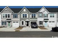 Two-story townhouses with attached garages and neutral-colored siding at 2055 Nw Parow Ln Nw # A, Calabash, NC 28467