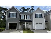 Charming two-story townhome with gray siding, black shutters, and attached garages at 265 Christiana Ln. # F, Myrtle Beach, SC 29579