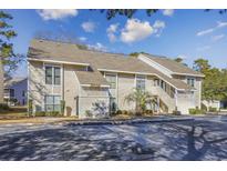 Attractive exterior of a two-story condo building with ample parking at 4434 Little River Inn Ln. # 205, Little River, SC 29566