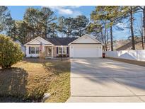 Brick ranch home with attached garage and landscaped yard at 5933 Rahnavard Blvd., Myrtle Beach, SC 29588