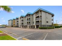 Coastal condo building with parking and ocean views at 6000 N Ocean Blvd. # 317, North Myrtle Beach, SC 29582