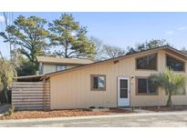 Well-maintained light beige single story home with mature trees and landscaping at 610 35Th Ave. N # A, Myrtle Beach, SC 29579