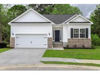 Newly built home with white siding, gray door, and brick accents at 640 Woodside Dr., Conway, SC 29526