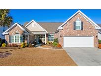 Brick home with a two-car garage and manicured lawn at 858 Edgewater Dr., Murrells Inlet, SC 29576