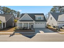 Charming craftsman style home with gray siding, stone accents, and a two-car garage at 1113 Mary Read Dr., North Myrtle Beach, SC 29582