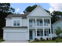 Two-story white house with gray roof, blue shutters, and a two-car garage at 114 Ranch Haven Dr., Murrells Inlet, SC 29576