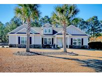 Beautiful one-story home with gray siding, stone accents, and palm trees at 230 Kellys Cove Dr., Conway, SC 29526