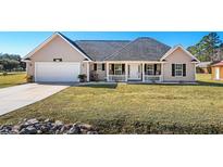 One-story house with attached garage and landscaped yard at 2579 Allen Dew Rd., Conway, SC 29527