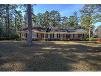 Brick ranch house with large yard and mature trees at 300 Mcarthur St., Tabor City, NC 28463