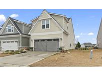 Two-story home with gray garage door and light beige siding at 331 Golan Circle # A, Myrtle Beach, SC 29579