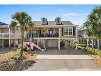 Two-story beach house with elevated foundation, garage, and spacious deck at 403 36Th Ave. N, North Myrtle Beach, SC 29582