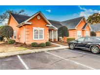 Charming single-story home with a well-maintained lawn, lush landscaping, and a private parking area at 4660 Lightkeepers Way # 37A, Little River, SC 29566