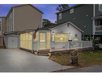 Charming cottage with white exterior, deck, and screened porch at 6001 - 1861 S Kings Hwy., Myrtle Beach, SC 29575