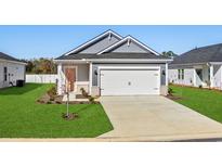 Newly built home with gray siding, white garage door, and landscaped lawn at 842 Cypress Preserve Circle, Longs, SC 29568