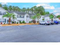 Front view of townhouses with parking and landscaping at 880 Fairway Dr. # 302Bb, Longs, SC 29568