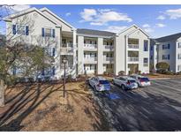 Attractive condo building featuring multiple stories and private balconies, surrounded by well-kept landscaping and ample parking at 901 West Port Dr. # 1706, North Myrtle Beach, SC 29582