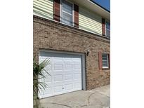 Brick home with attached garage and white garage door at 105 S Merriman Rd., Georgetown, SC 29440