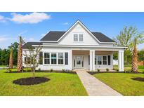 Beautiful new construction home with manicured lawn and light brick walkway at 1201 Possum Trot Rd., North Myrtle Beach, SC 29582