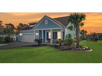 Beautiful light blue home with a two-car garage and landscaped lawn at 1810 N Cove Ct., North Myrtle Beach, SC 29582