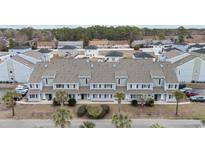 Aerial view of townhouses with gray roofs and light blue siding, surrounded by lush greenery at 1890 Colony Dr. # 17N, Myrtle Beach, SC 29575