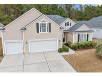 Two-story house with beige siding, a gray roof, and a two-car garage at 311 Highfield Loop, Myrtle Beach, SC 29579