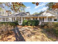 Craftsman style home with a large front porch and mature landscaping at 4705 Harness Ln., Murrells Inlet, SC 29576