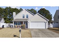 Beige house with a white garage door and landscaping at 4821 Southgate Pkwy., Myrtle Beach, SC 29579