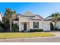 Charming one-story house with a green door and palm trees at 4918 Old Appleton Way, North Myrtle Beach, SC 29582