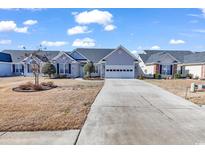 Single-story home with gray siding, brick accents, and a two-car garage at 541 Sand Ridge Rd., Conway, SC 29526