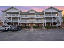 Brick building exterior with multiple units, balconies, and parking at 5751 Oyster Catcher Dr. # 931, North Myrtle Beach, SC 29582