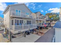 Two-story home with gray siding, multiple balconies, and a carport at 6001-1027 S Kings Hwy., Myrtle Beach, SC 29575