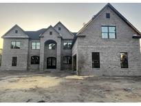 Elegant brick house with symmetrical design and modern windows offers classic charm and contemporary appeal at 7053 Byrnes Ln., Myrtle Beach, SC 29588