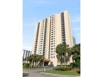 High-rise beachfront building with palm trees and ample parking at 8560 Queensway Blvd. # 304, Myrtle Beach, SC 29572