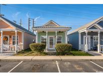 Charming cottage style home with light green exterior and landscaping at 111 Addison Cottage Way, Murrells Inlet, SC 29576