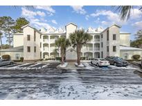 Three-story condo building with parking and snow on the ground at 112 Cypress Point Ct. # 202, Myrtle Beach, SC 29579