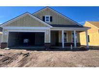 New construction home with two-car garage and front porch at 1245 Crested Iris Way, North Myrtle Beach, SC 29582