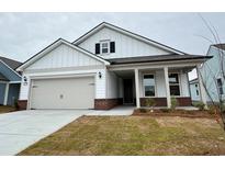 Charming single-story home with a two-car garage, covered entry, white siding, and brick accents at 1245 Crested Iris Way, North Myrtle Beach, SC 29582