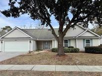 One-story house with attached garage and landscaped lawn at 201 Melody Gardens Dr., Surfside Beach, SC 29575