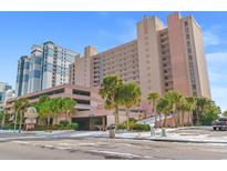 Sandcastle South oceanfront resort building with parking and palm trees at 2207 S Ocean Blvd. # 1119, Myrtle Beach, SC 29577