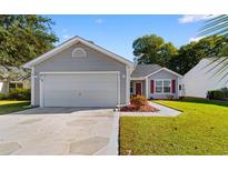 Gray house with a two-car garage and manicured lawn at 244 Mckendree Ln., Myrtle Beach, SC 29579