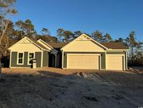 Newly constructed home with a two-car garage and attractive curb appeal at 25 Northbrook Dr, Murrells Inlet, SC 29576