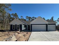 Charming single-story home with a three car garage, a concrete driveway, and blue siding with white accents at 25 Northbrook Dr, Murrells Inlet, SC 29576