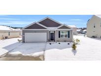 Gray siding house with white garage door and snow covered lawn at 275 Columbus St., Conway, SC 29526