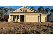 Two-story craftsman style home with beige exterior and two-car garage at 35 Northbrook Dr, Murrells Inlet, SC 29576