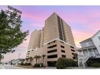 A high-rise condo building features multi-level parking, beach access and nearby shopping and restaurants at 4103 N Ocean Blvd. # 504, North Myrtle Beach, SC 29582