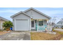 Charming single-story home features a decorative fence, front porch, and an attached garage at 412 Chesterfield Ct., Myrtle Beach, SC 29577